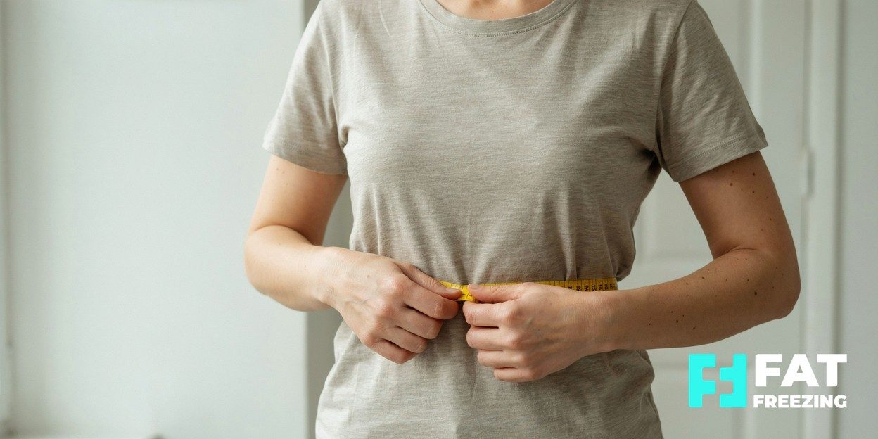 Photorealistic editorial photograph of a person measuring their waist with a tape measure in soft natural light