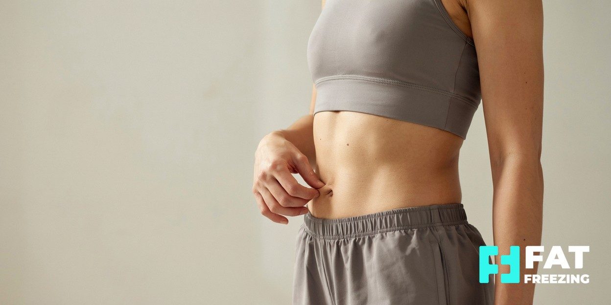 Photograph of a person pinching a small fold of fat at their midsection
