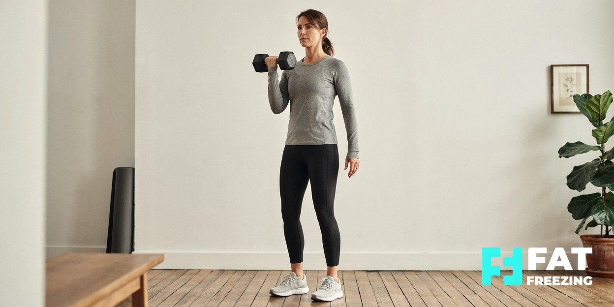 Woman in her forties lifting a dumbbell during a strength training session