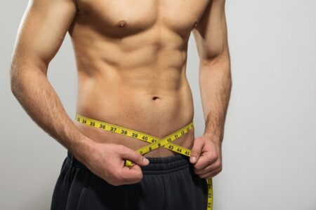 Man measuring tape around his waist