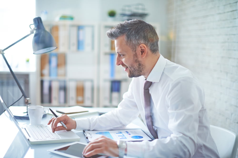 Man white shirt tie is typing laptop