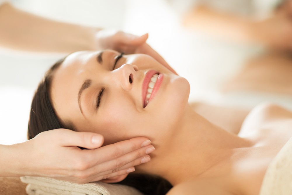 Woman getting facial massage spa