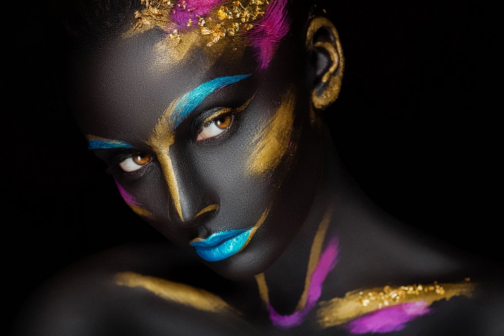 Woman gold blue face paint