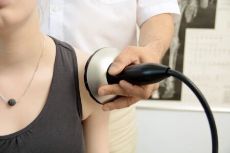 Woman is blow drying her hair hair dryer