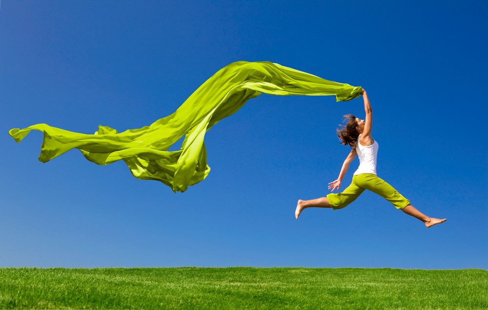 Woman jumping air green scarf